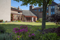 Provost Lawrence Court building with flowers,tree and grass area in foreground