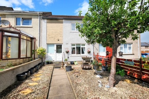 Front of property showing a front garden with path and chuckies.