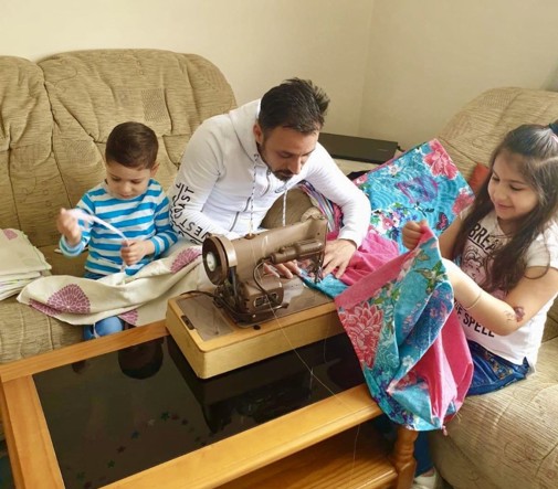 Syrian family sewing textiles to help their community