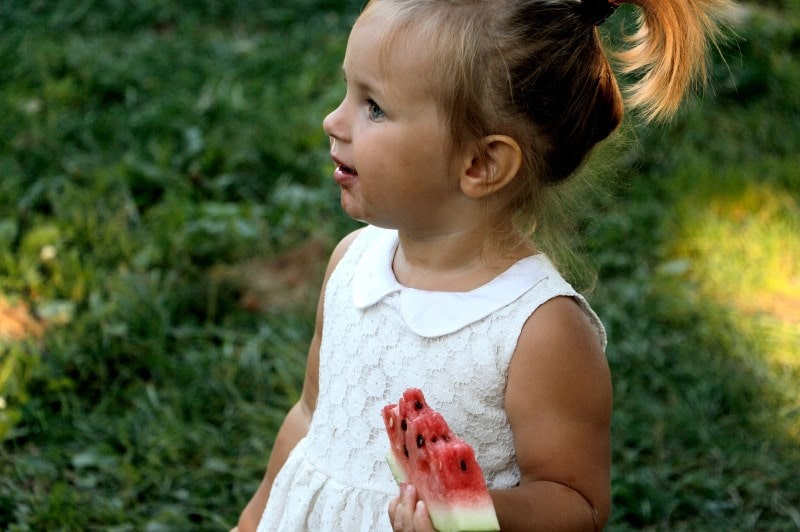 Little girl eating watermelon