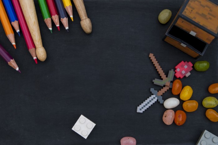 Chalk board with coloured pencils, note pad, calculator and earphones