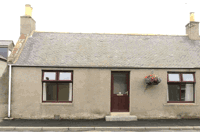 Front of 87 High Street in Cuminestown showing front door and a window on both sides of door