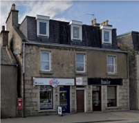 Front of property showing building with flats above two shops