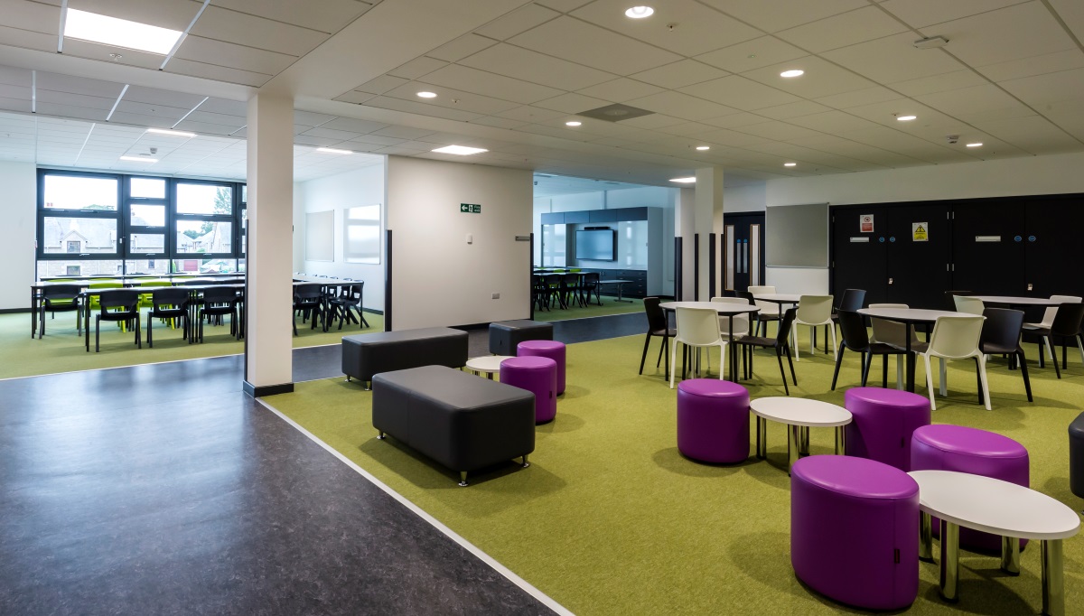 Large open plan room with different sized tables and chairs