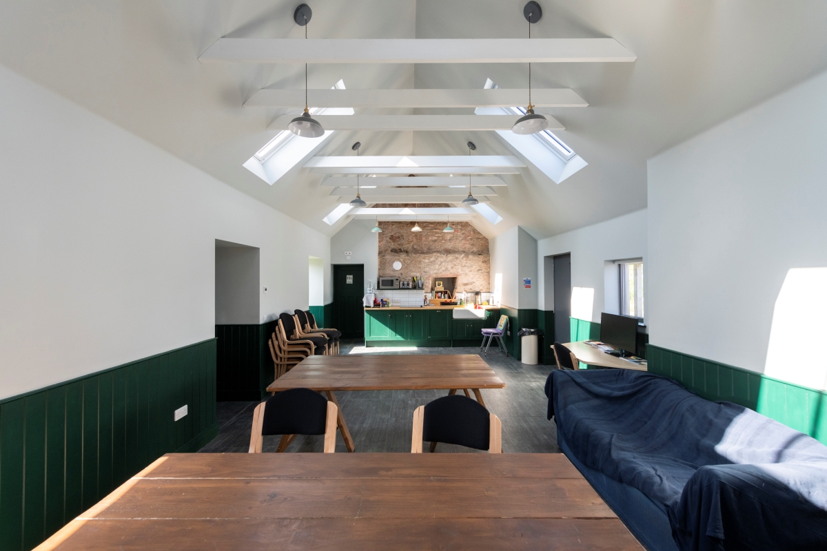 Room with slanted ceilings, tables and chairs