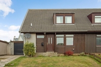 3 Invergarry Park, St Cyrus showing semi detached house with grass garden area and paved driveway