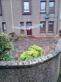 Semi-detached house, with tiled garden and rotary washing lines
