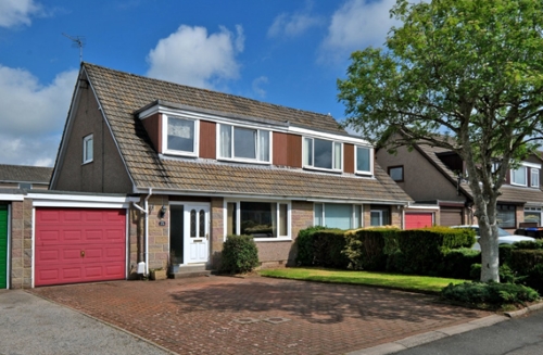 Semi-detached house at 32 Kinmundy Avenue, Westhill with garage, private driveway and tree at end of drive