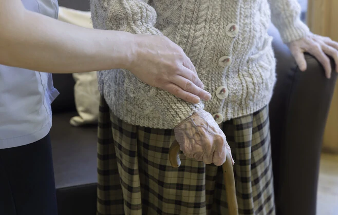Social Care Officer caring for elderly female resident at Edenholme Care Home