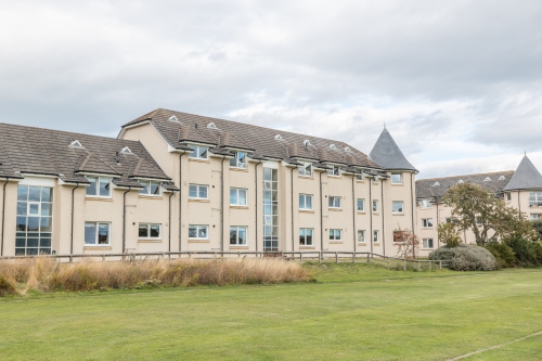 Front of 35 Cowie Park, Stonehaven showing block of flats with grass area in front