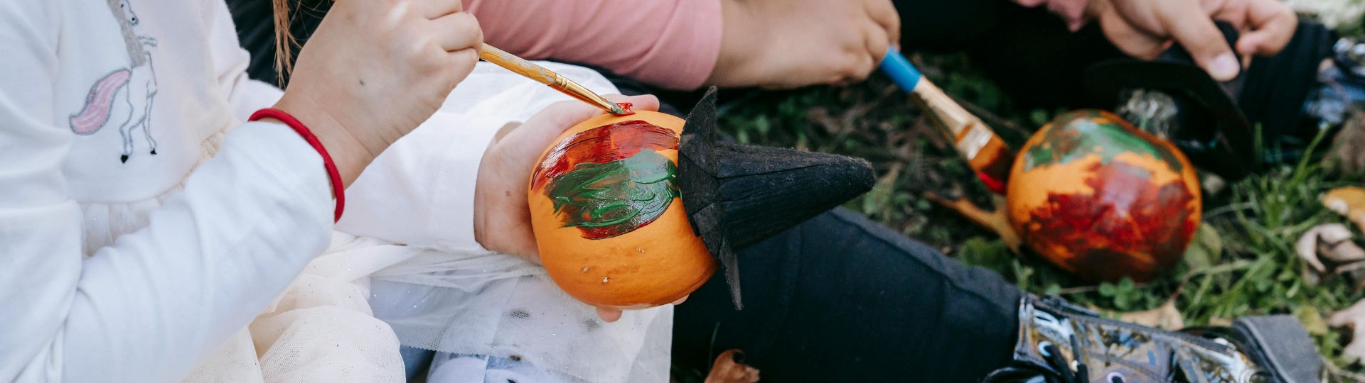Children painting pumpkins