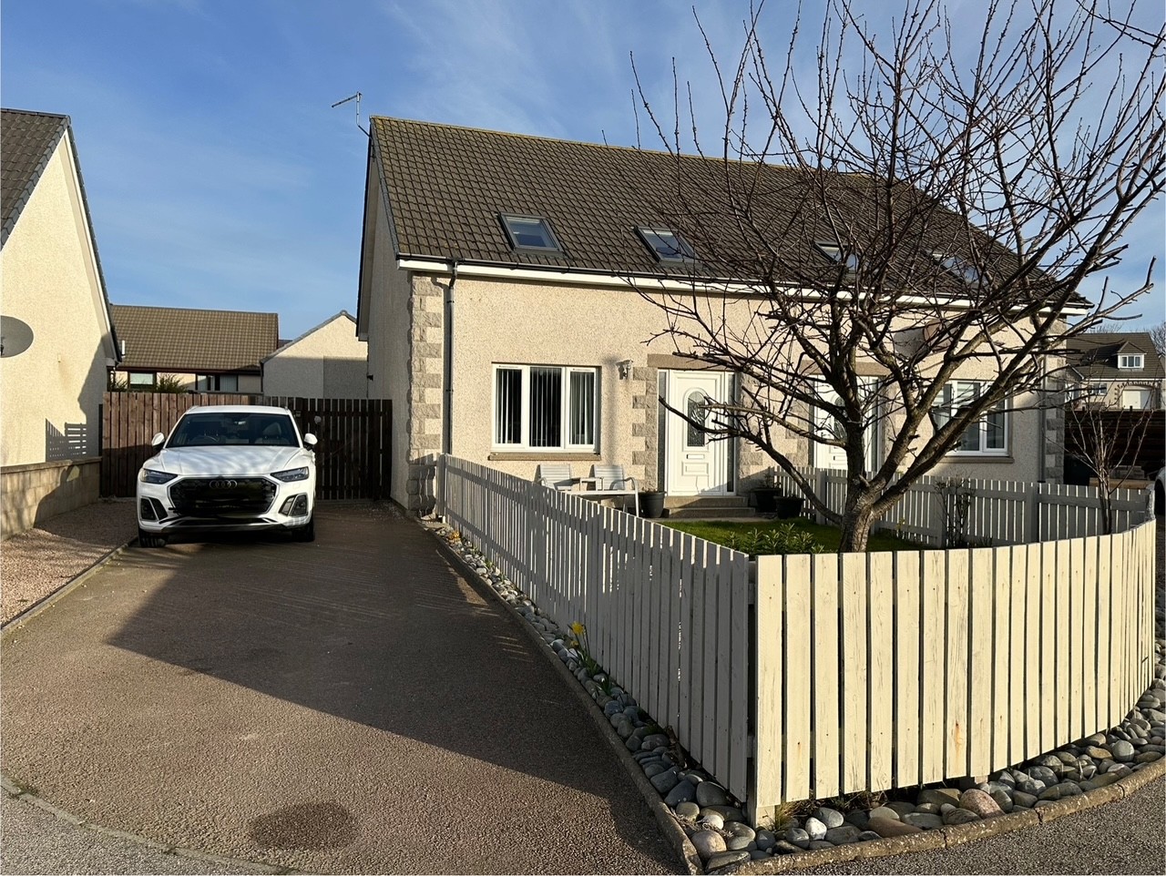 Front of the house at 34A Knock Ave Whitehills with driveway on a side and fenced off front garden