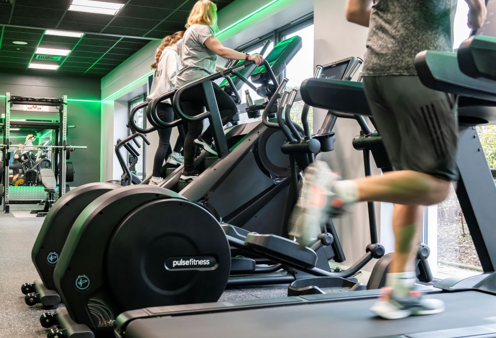 Fraserburgh Community and Sports Centre gym, with two people on step machines and one on a treadmill. 