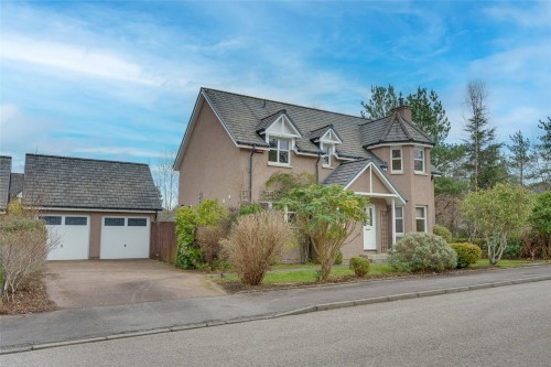 Front of detached property with driveway and garage