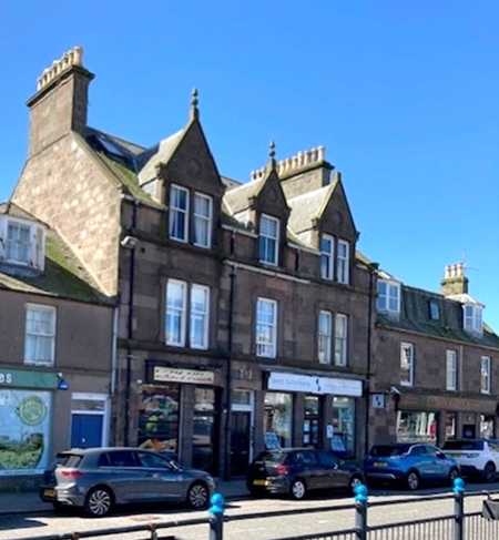 Street view of block of flats at 9 Market Square Stonehaven with cars parked on street
