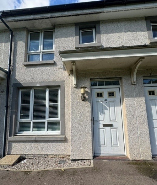 Front of 61 Old Aberdeen Road, Balmedie with white front door with canopy above