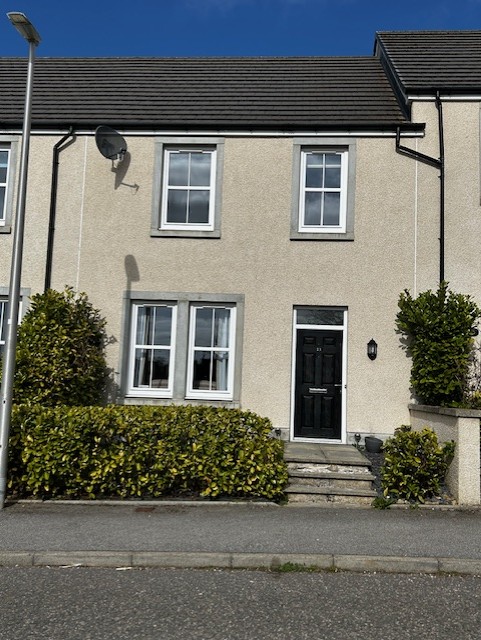 Front of the terraced house at 13 Denwell Drive with hedge and steps leading to the door