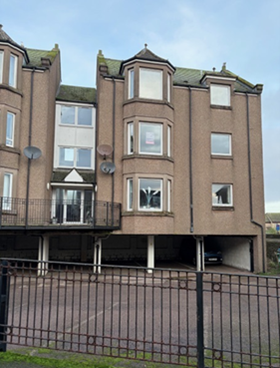 Front of the block at Bond Mews, Stonehaven showing carpark at the ground level and flats above