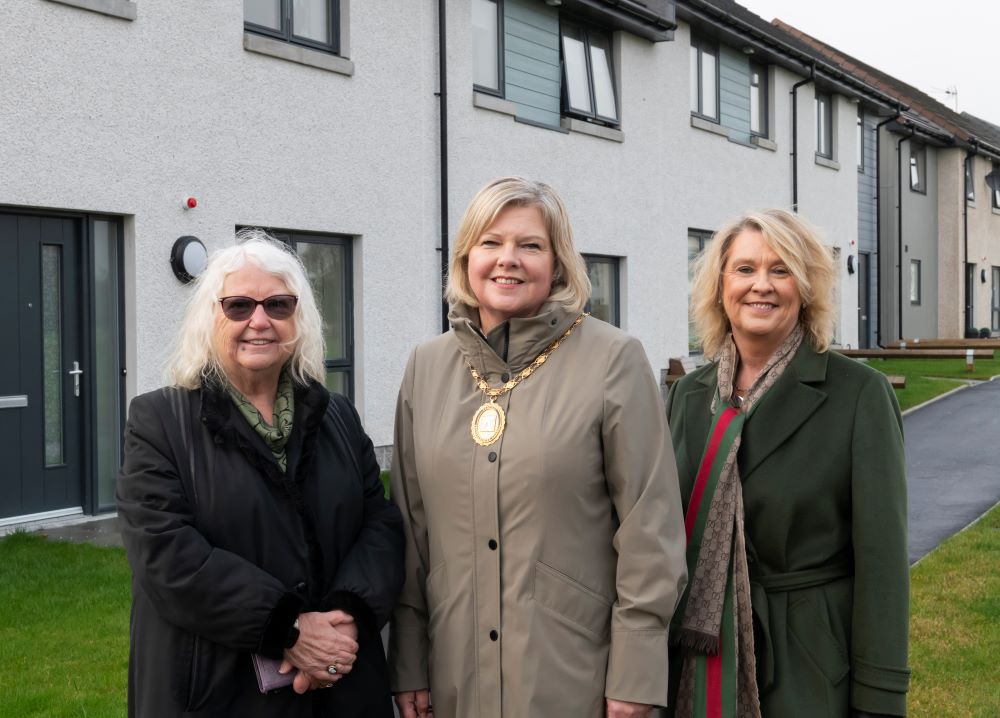 A photo of Cllr Anne Buchan, Provost Judy Whyte, and Cllr Dianne Beagrie outside properties at Nether Aden, Mintlaw.