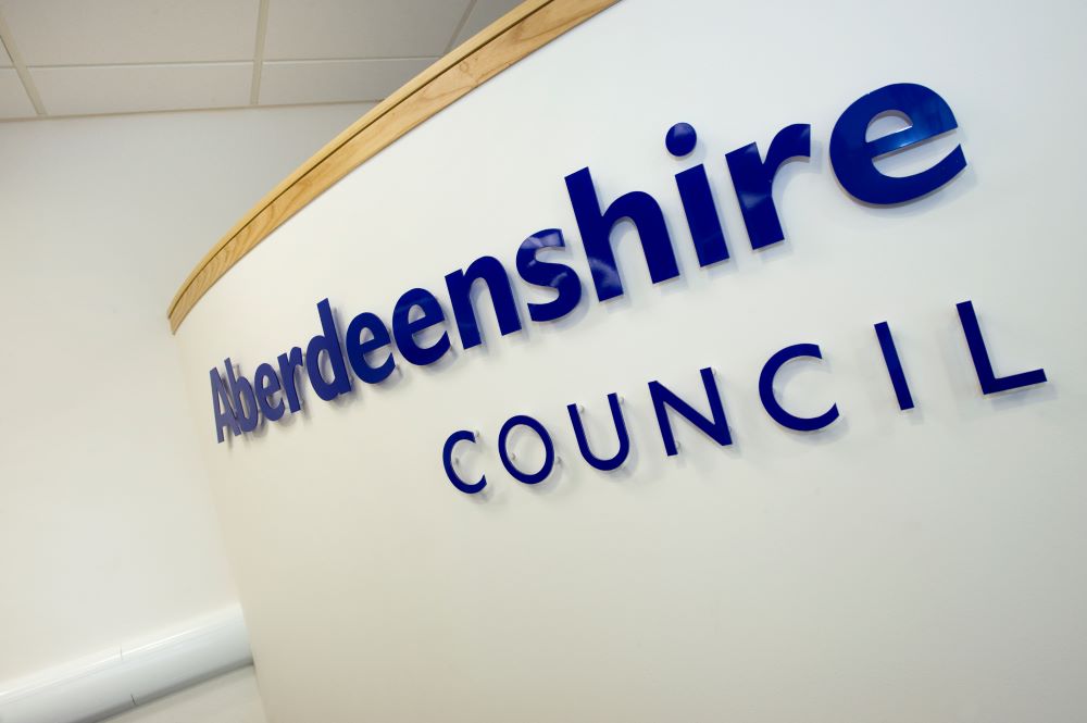 An Aberdeenshire Council sign on a cream-coloured panel. 
